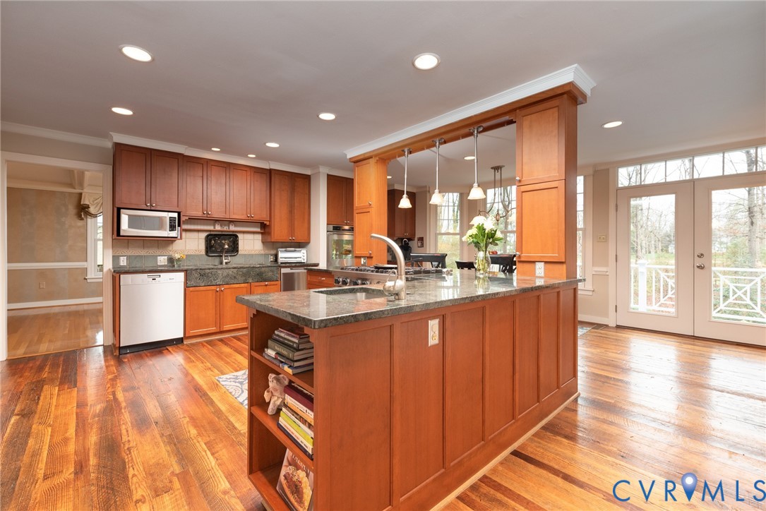 11920 Rothbury Drive Richmond, VA 23236 - Photo 10 of 68 a kitchen with stainless steel appliances granite countertop a refrigerator a sink dishwasher a stove and white countertops with wooden floor