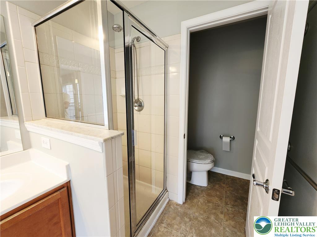 8513 Gateway Road Breinigsville, PA 18031 - Photo 31 of 45 A well-appointed bathroom offers a glass-enclosed shower and a separate toilet area for privacy.