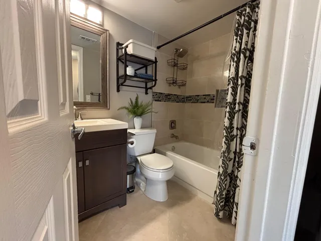 a bathroom with a toilet a sink and a shower