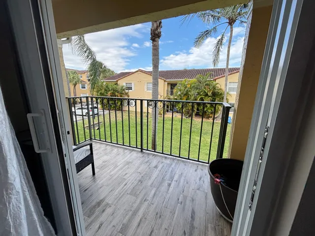 a view of a balcony with wooden floor