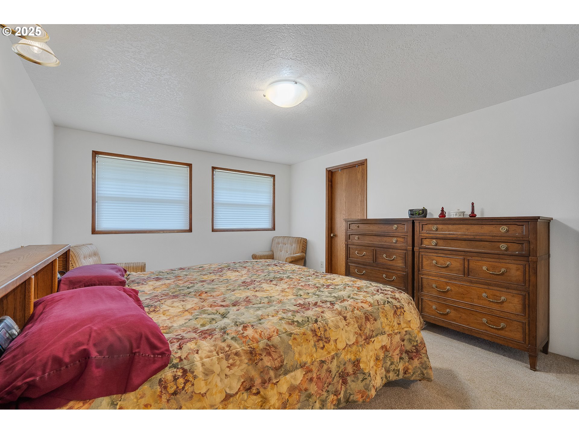 9065 Trask River Road Tillamook, OR 97141 - Photo 12 of 48 a bedroom with a bed and a dresser