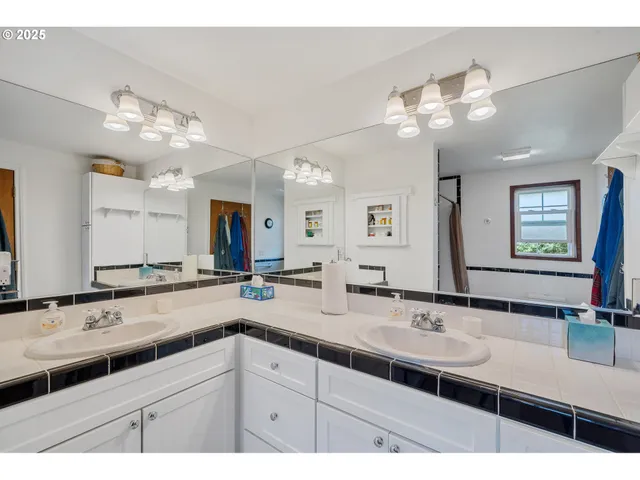 a bathroom with a sink a large mirror and vanity