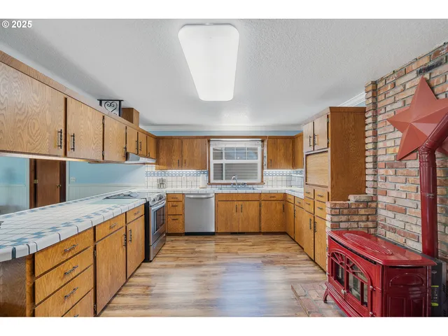 a kitchen with a stove a sink and a refrigerator