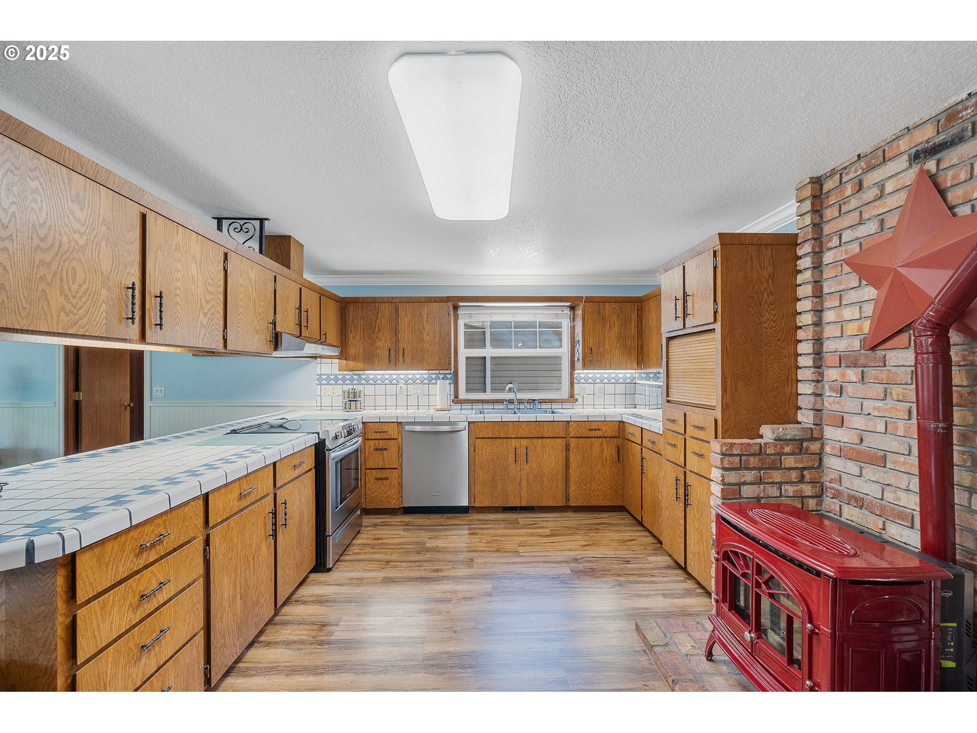 9065 Trask River Road Tillamook, OR 97141 - Photo 16 of 48 a kitchen with a stove a sink and a refrigerator