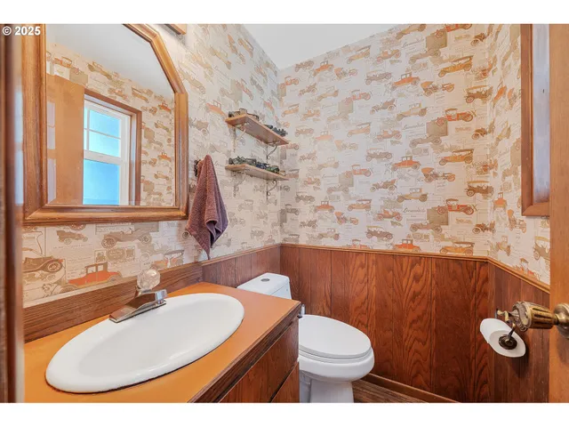 a bathroom with a sink a toilet and mirror