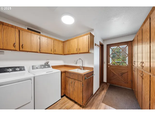 a utility room with sink dryer and washer
