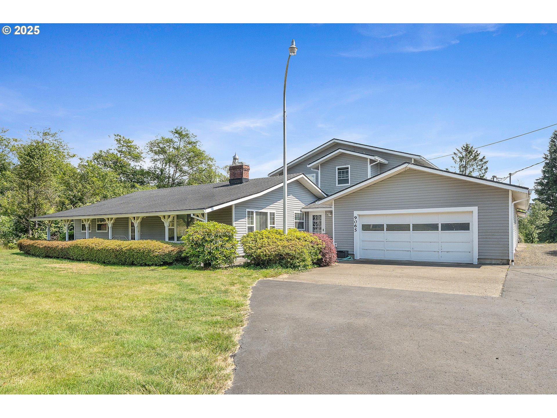 9065 Trask River Road Tillamook, OR 97141 - Photo 2 of 48 a front view of a house with a garden