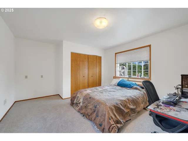 a bedroom with a bed and a dresser