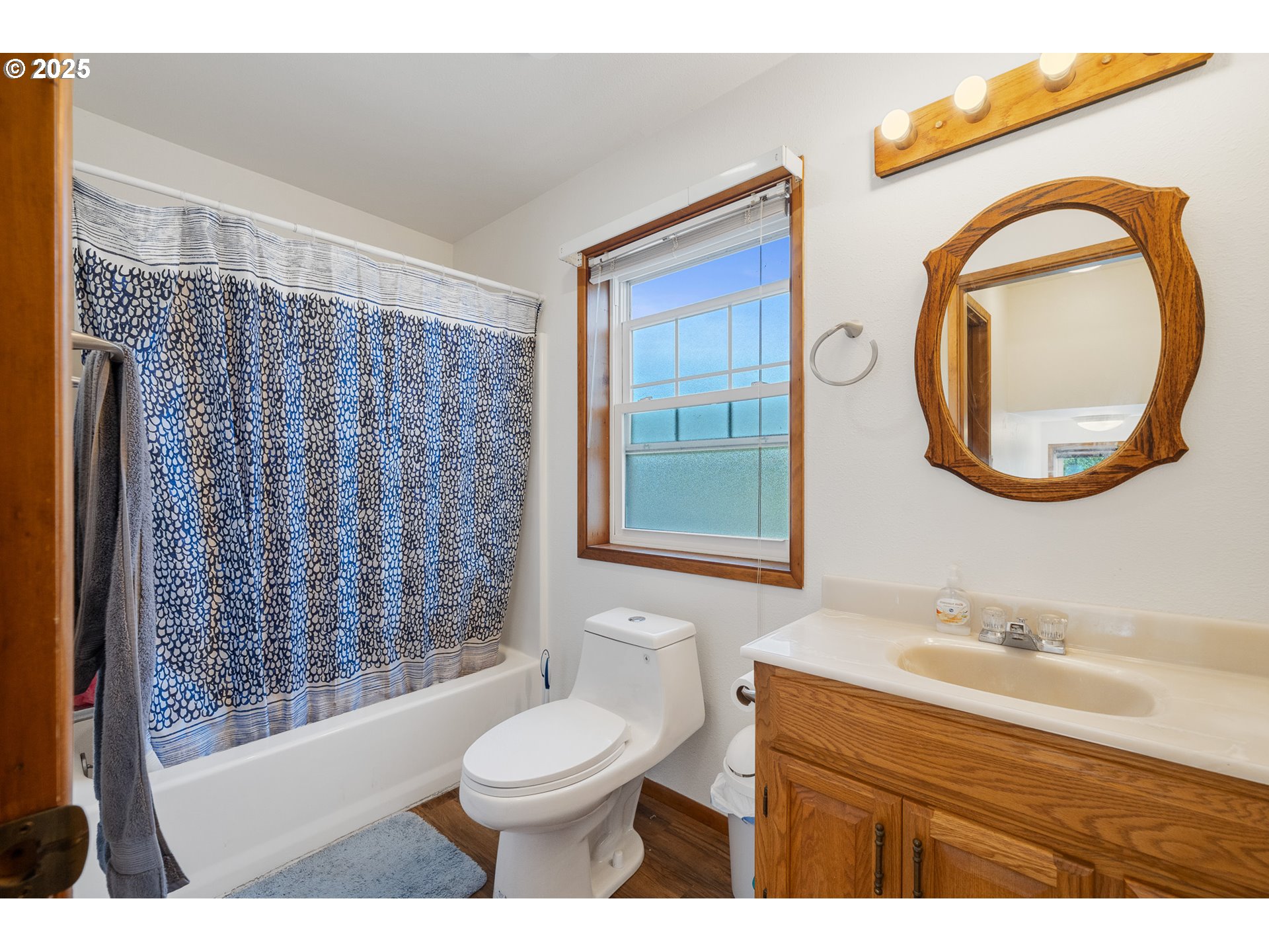 9065 Trask River Road Tillamook, OR 97141 - Photo 28 of 48 a bathroom with a toilet a sink a mirror a shower and a window