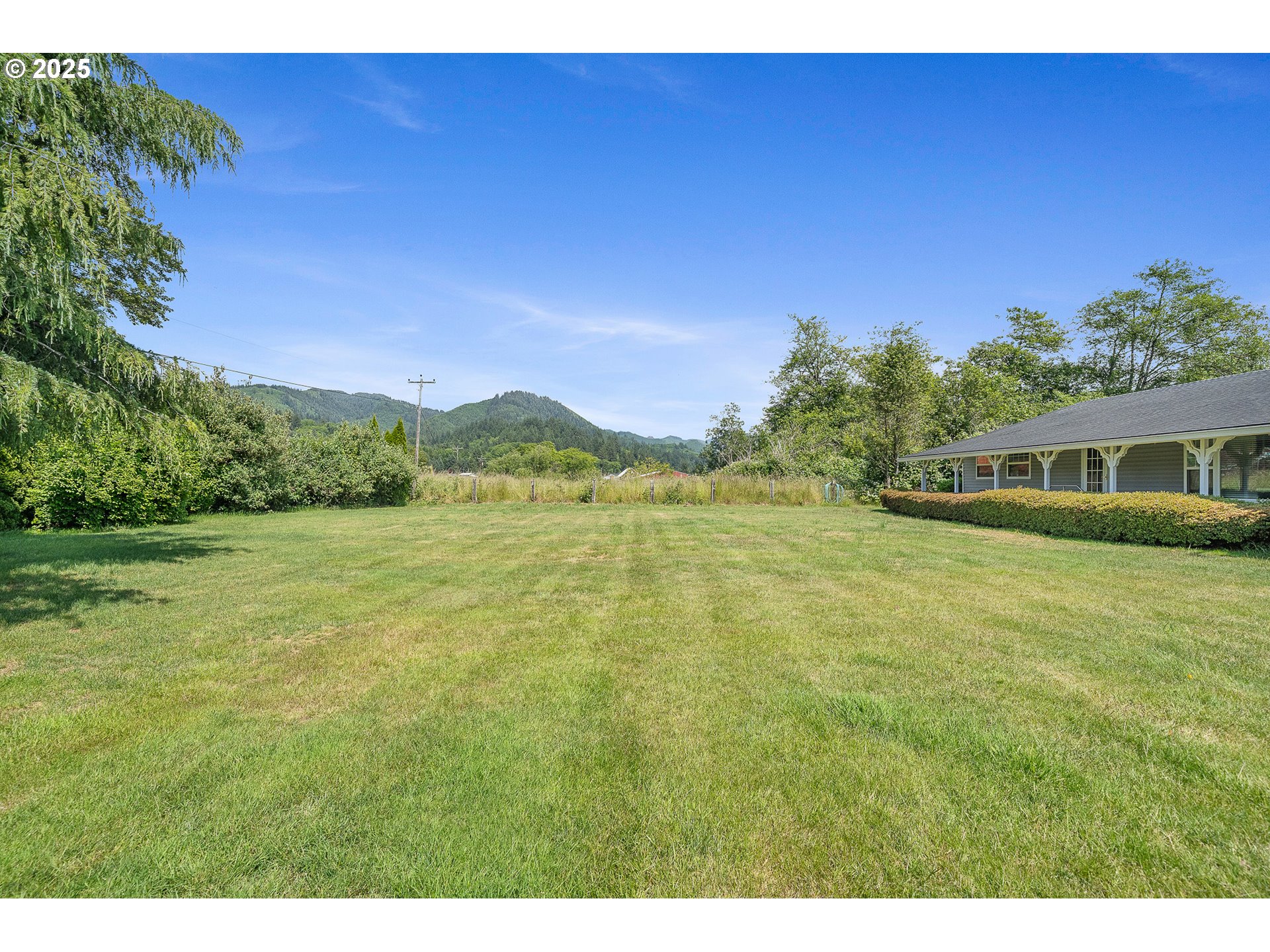 9065 Trask River Road Tillamook, OR 97141 - Photo 34 of 48 a front view of a house with a garden