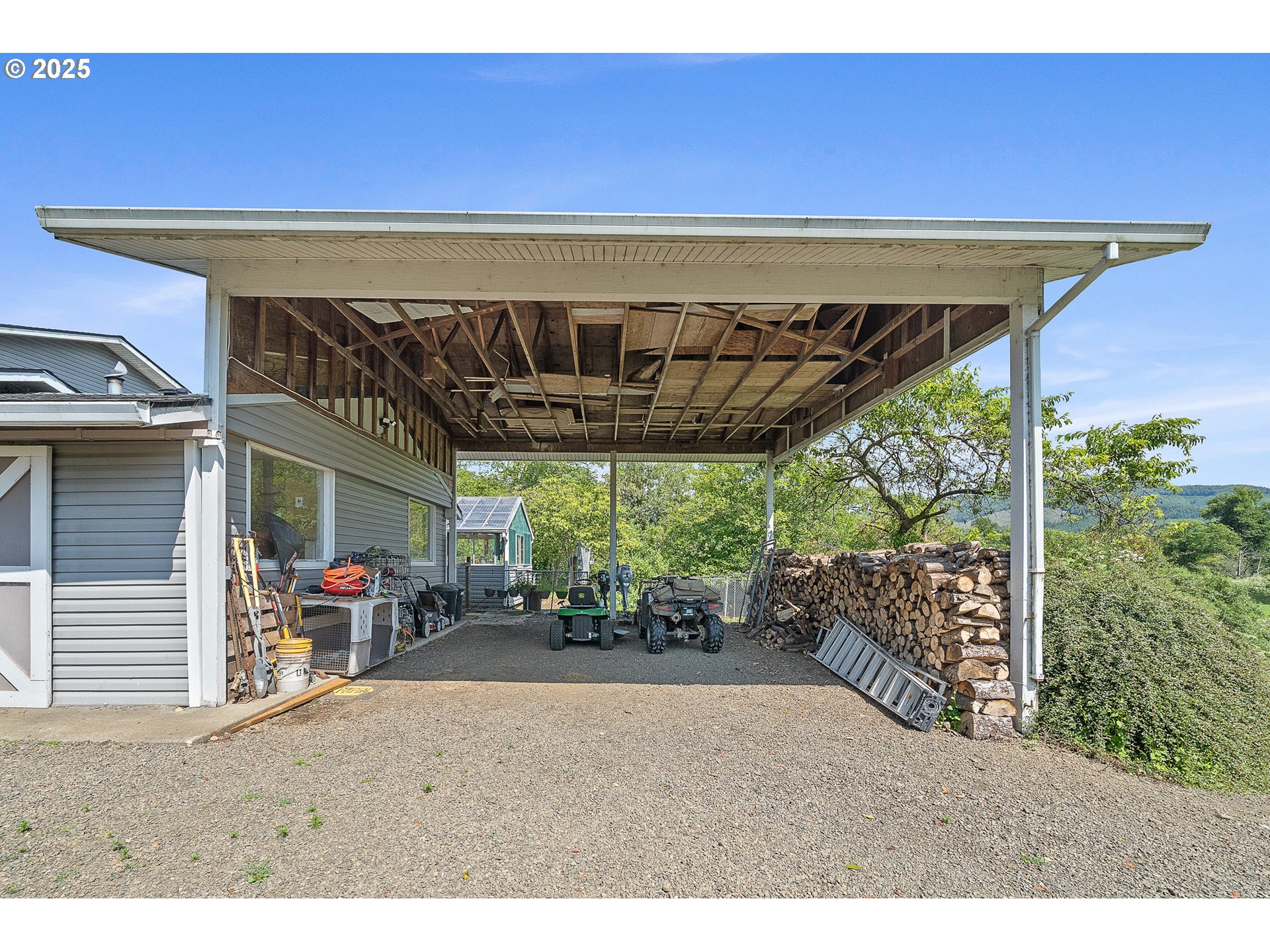 9065 Trask River Road Tillamook, OR 97141 - Photo 37 of 48 a view of a patio with table and chairs potted plants and floor to ceiling window