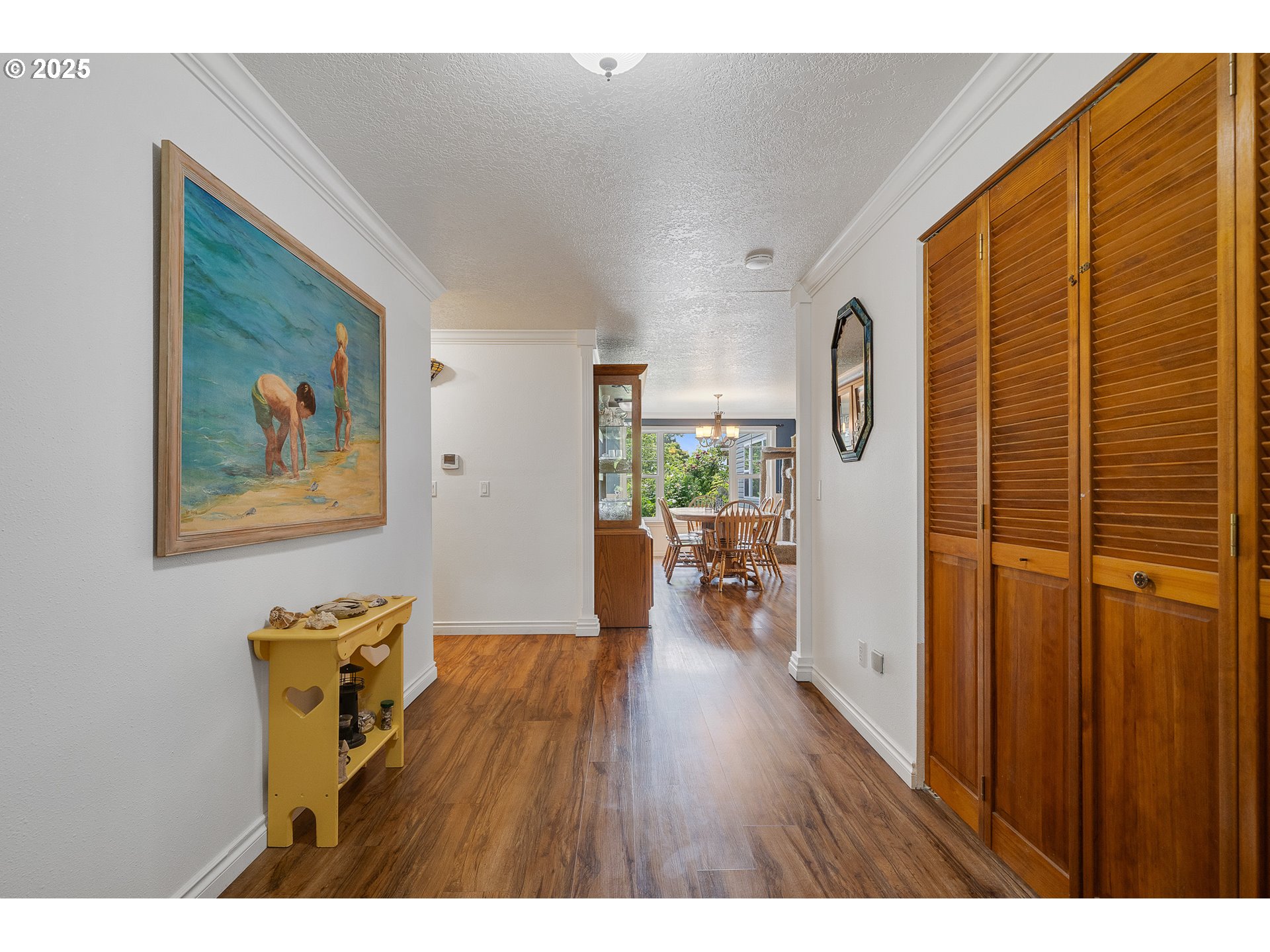 9065 Trask River Road Tillamook, OR 97141 - Photo 4 of 48 a view of a hallway with wooden floor and a living room