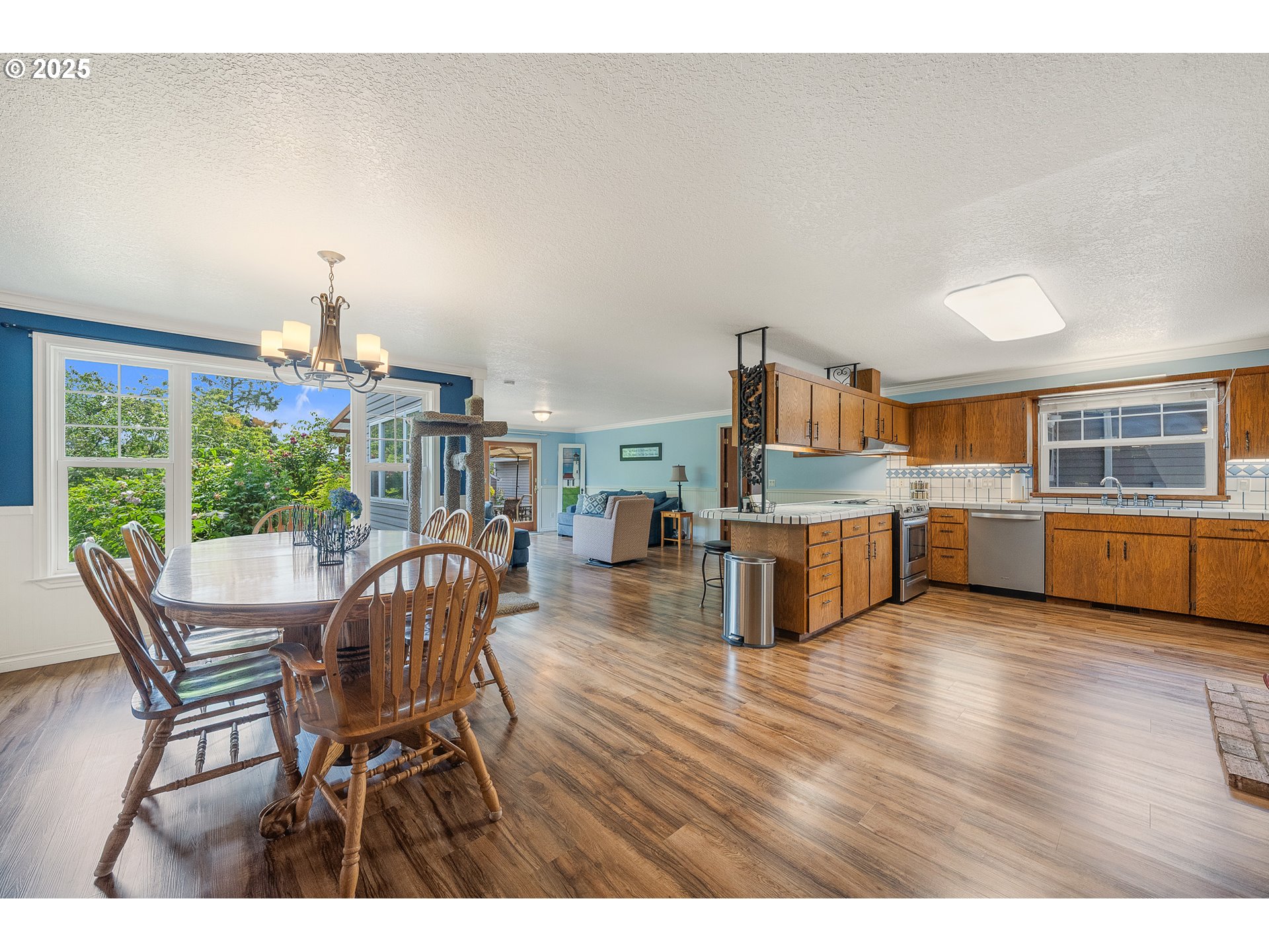 9065 Trask River Road Tillamook, OR 97141 - Photo 5 of 48 a living room with furniture wooden floor and a kitchen view