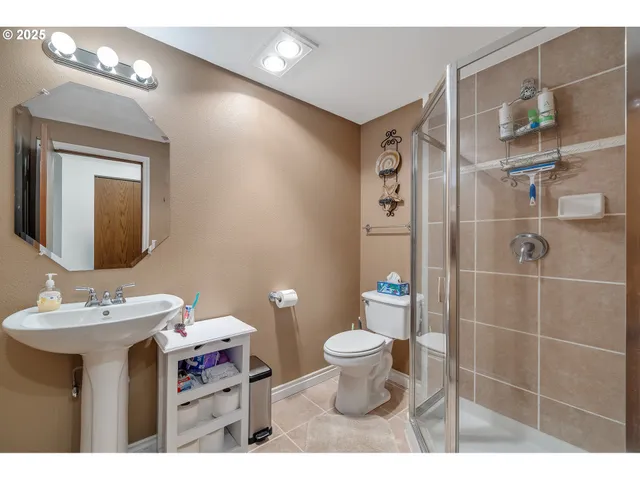 a bathroom with a sink toilet and shower