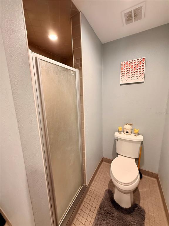 61 Perch Street Haines City, FL 33844 - Photo 16 of 79 a bathroom with a toilet and a shower