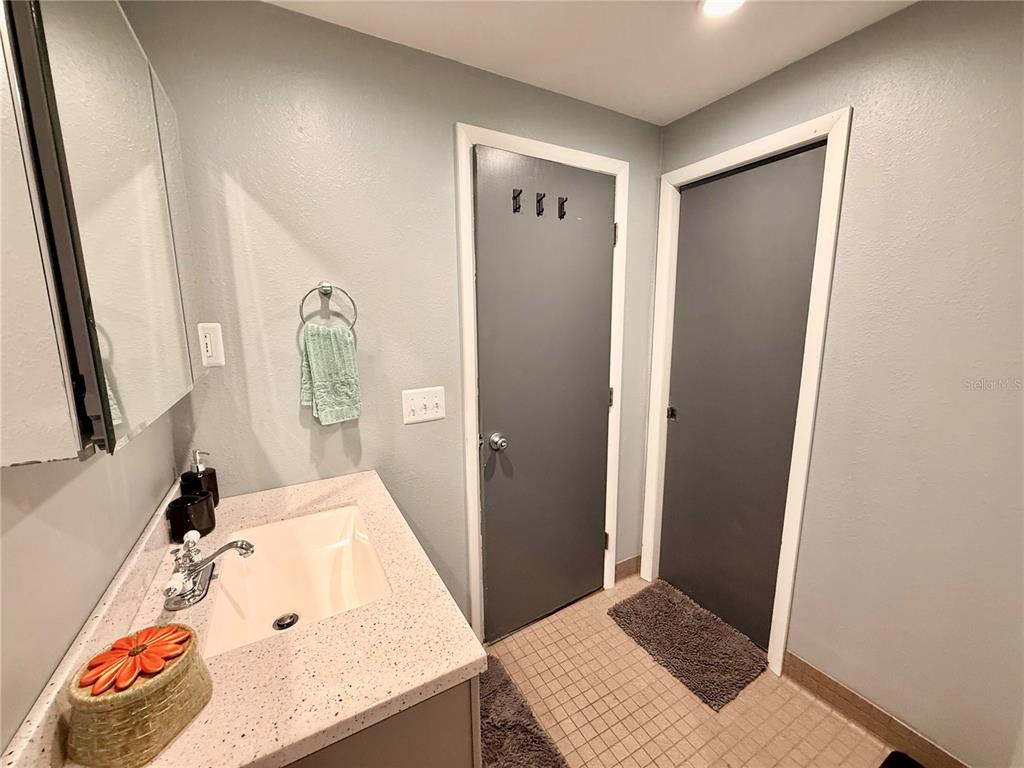 61 Perch Street Haines City, FL 33844 - Photo 19 of 79 a bathroom with a granite countertop sink and a mirror