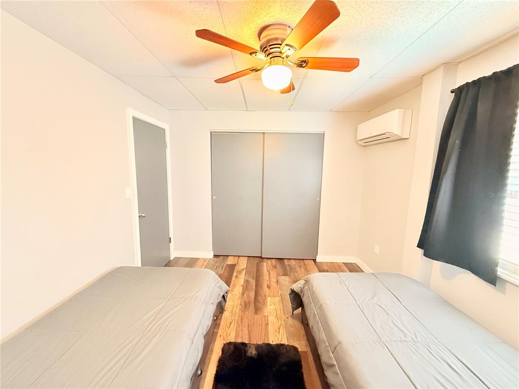 61 Perch Street Haines City, FL 33844 - Photo 29 of 79 a bedroom with a bed and a chandelier