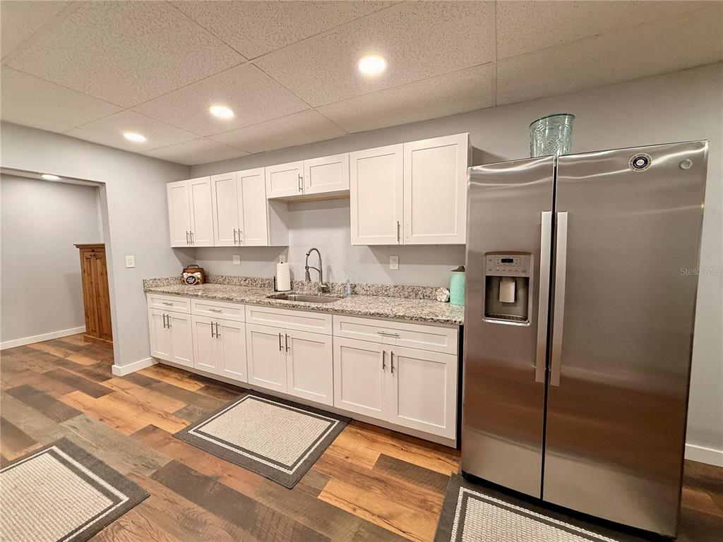 61 Perch Street Haines City, FL 33844 - Photo 4 of 79 a kitchen with refrigerator cabinets and a sink