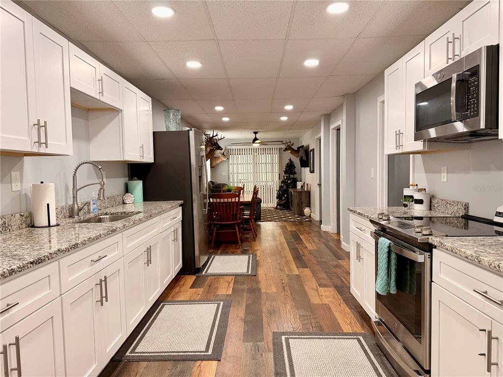 61 Perch Street Haines City, FL 33844 - Photo 5 of 79 a kitchen with stainless steel appliances granite countertop a sink stove and refrigerator