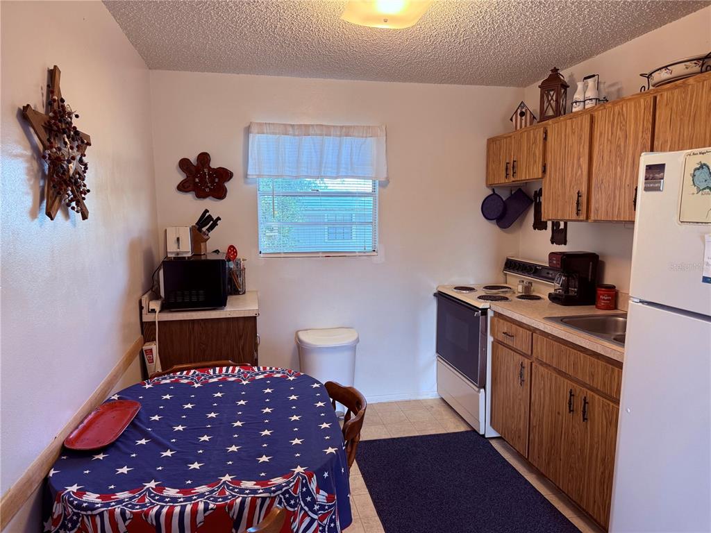 61 Perch Street Haines City, FL 33844 - Photo 57 of 79 a bedroom with a bed and a lamp on the dresser