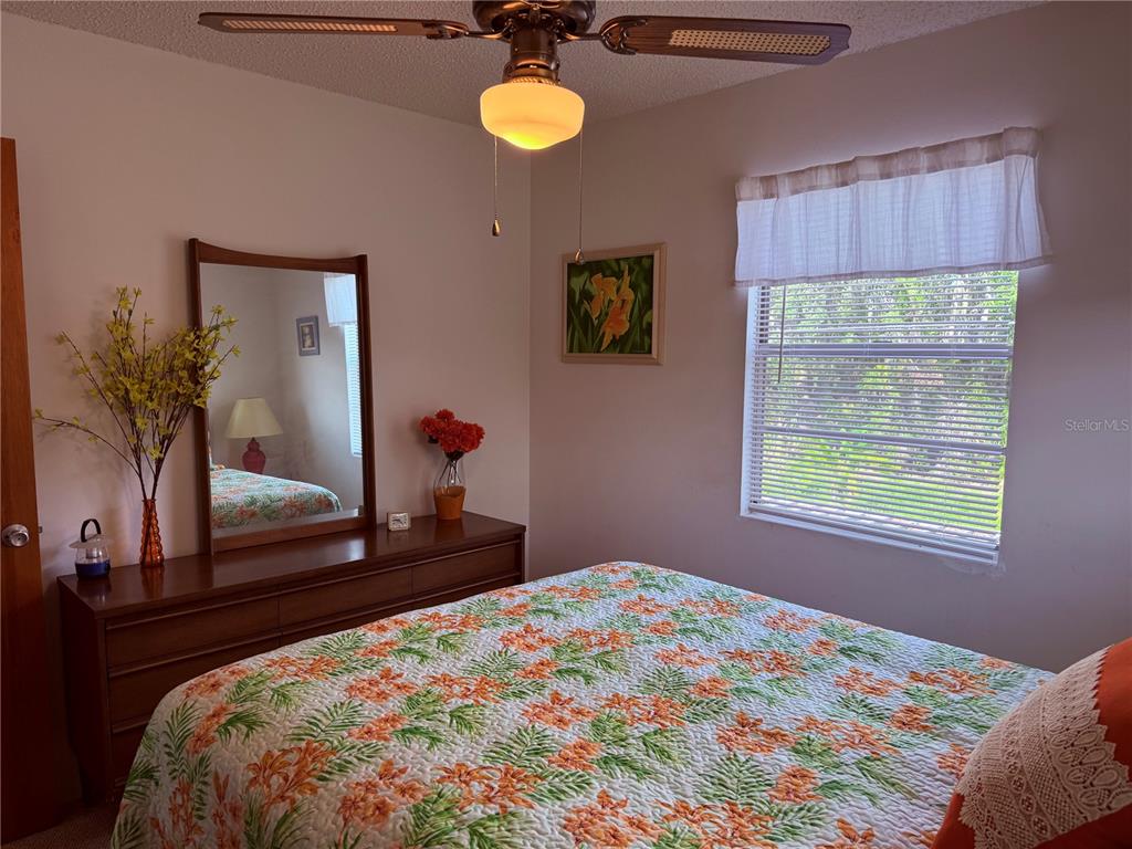 61 Perch Street Haines City, FL 33844 - Photo 64 of 79 a bedroom with a bed and a mirror
