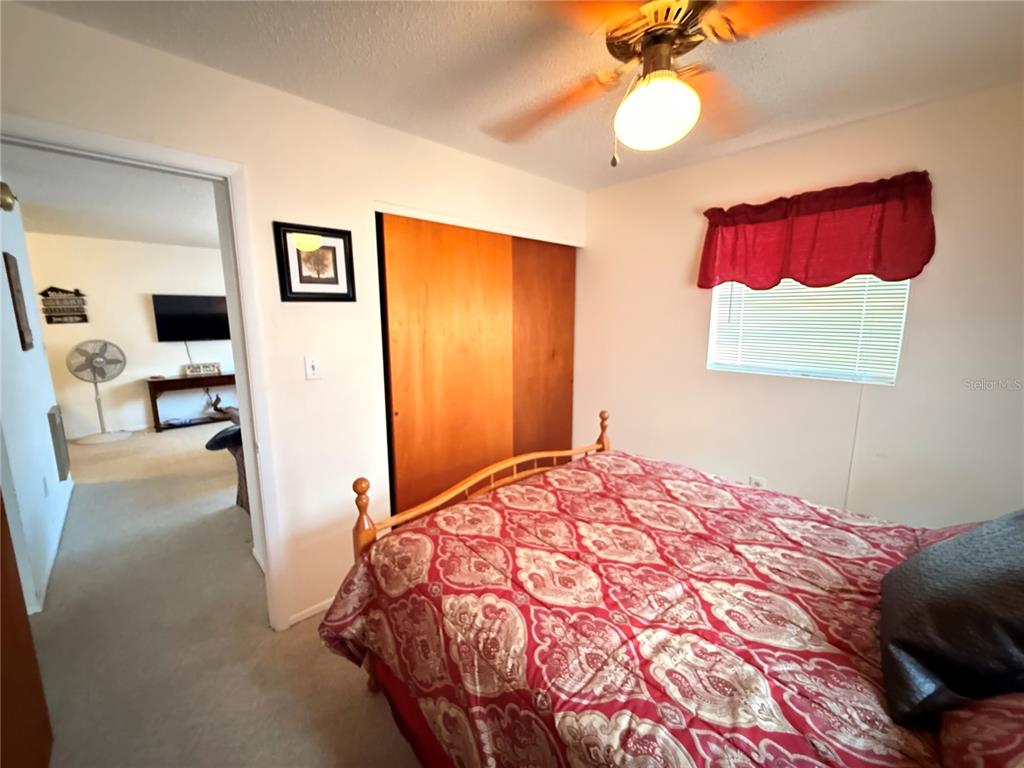 61 Perch Street Haines City, FL 33844 - Photo 68 of 79 a bedroom with a bed and a chandelier