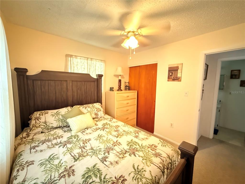 61 Perch Street Haines City, FL 33844 - Photo 70 of 79 a bedroom with a bed and a chandelier