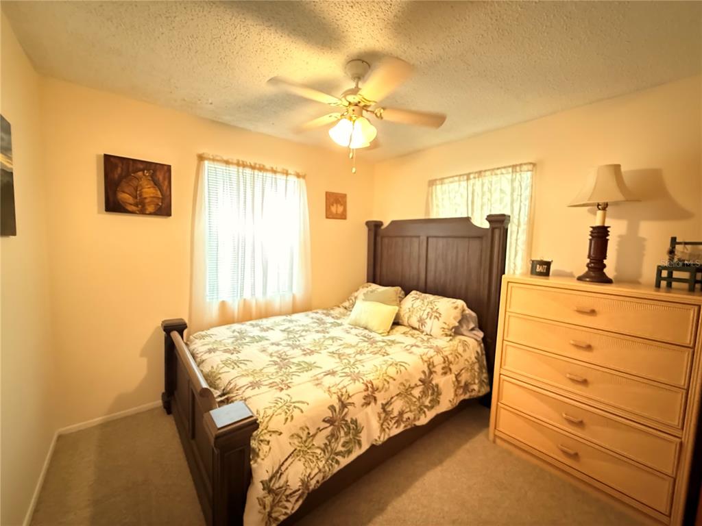 61 Perch Street Haines City, FL 33844 - Photo 71 of 79 a bedroom with a bed and a chandelier