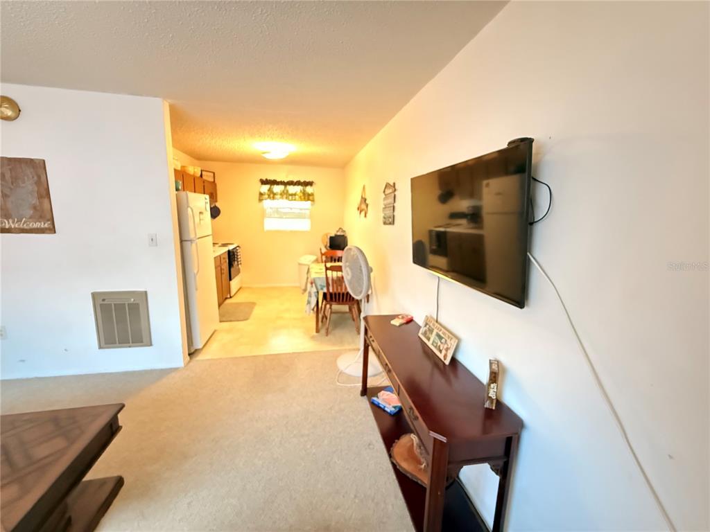 61 Perch Street Haines City, FL 33844 - Photo 73 of 79 a living room with furniture and a flat screen tv