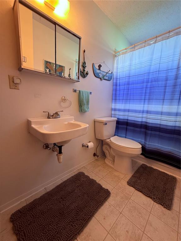 61 Perch Street Haines City, FL 33844 - Photo 75 of 79 a bathroom with a toilet a sink and mirror