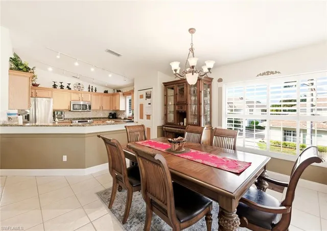 a dining room with furniture a rug and a chandelier