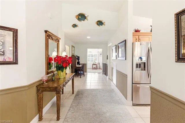a hallway with furniture and a potted plant