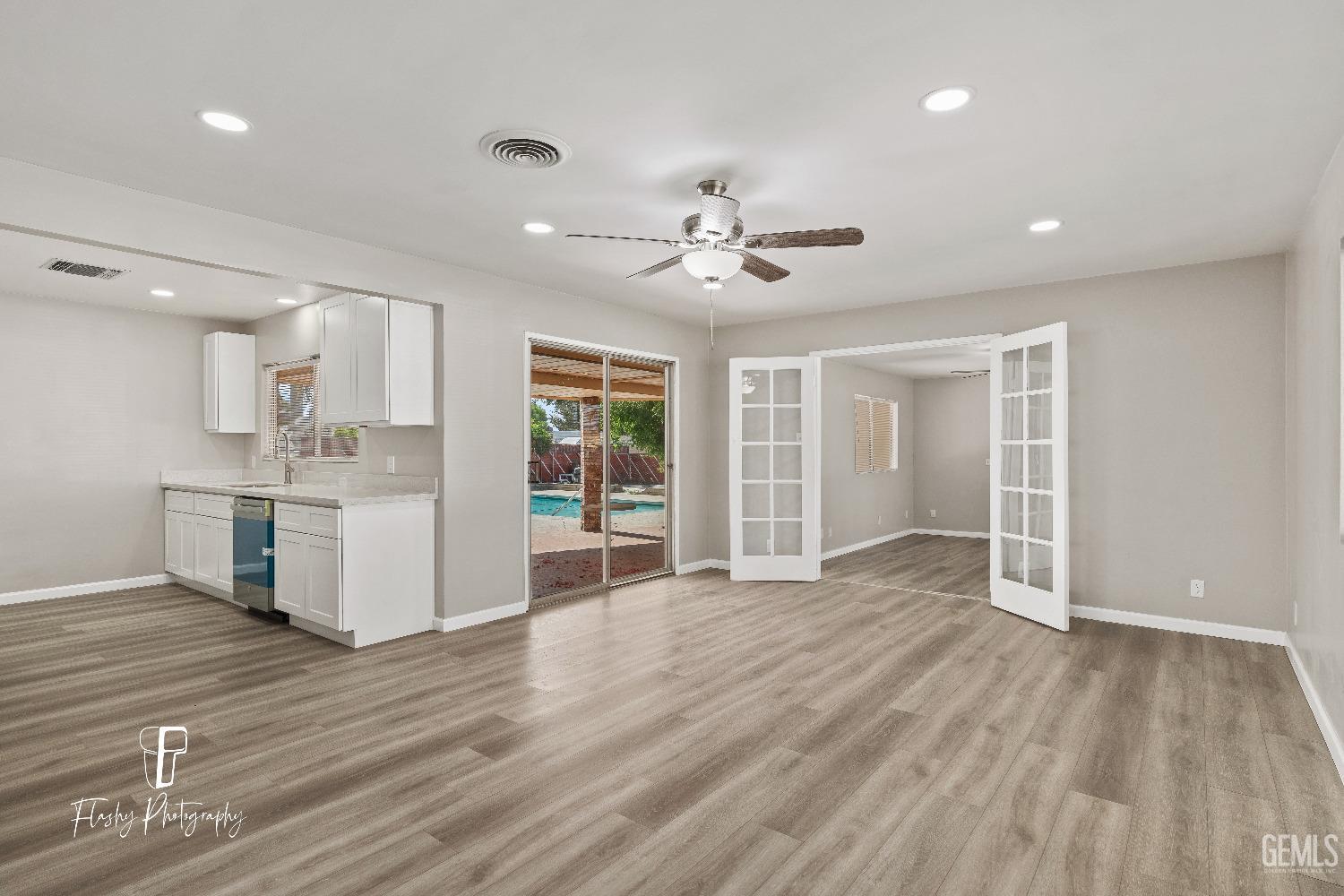 Undisclosed Address Bakersfield, CA 93308 - Photo 11 of 37 a view of an empty room with a window and wooden floor