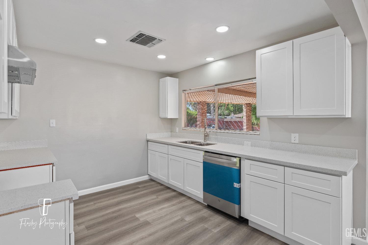 Undisclosed Address Bakersfield, CA 93308 - Photo 15 of 37 a kitchen with granite countertop white cabinets and white appliances