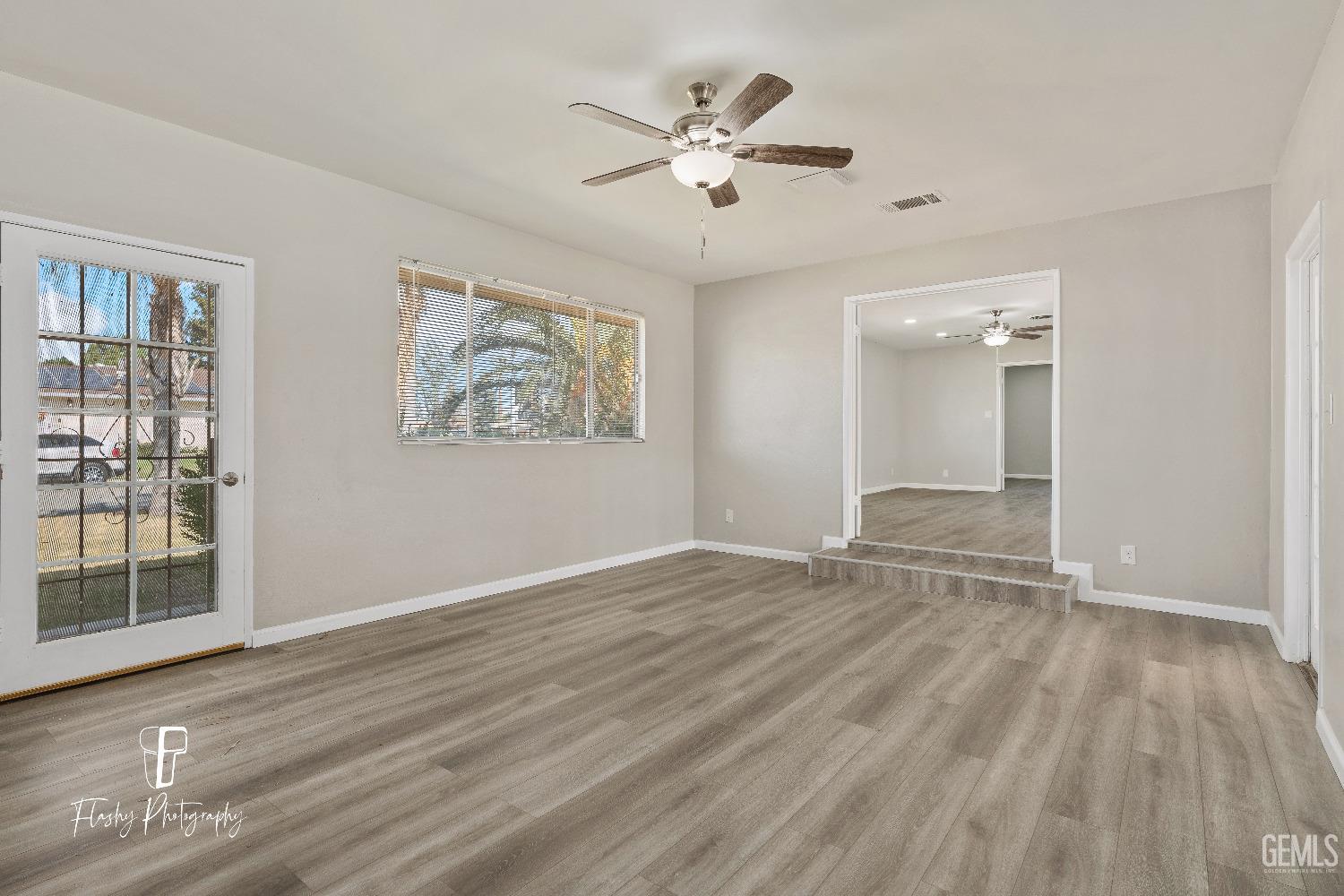 Undisclosed Address Bakersfield, CA 93308 - Photo 18 of 37 wooden floor in an empty room with a window