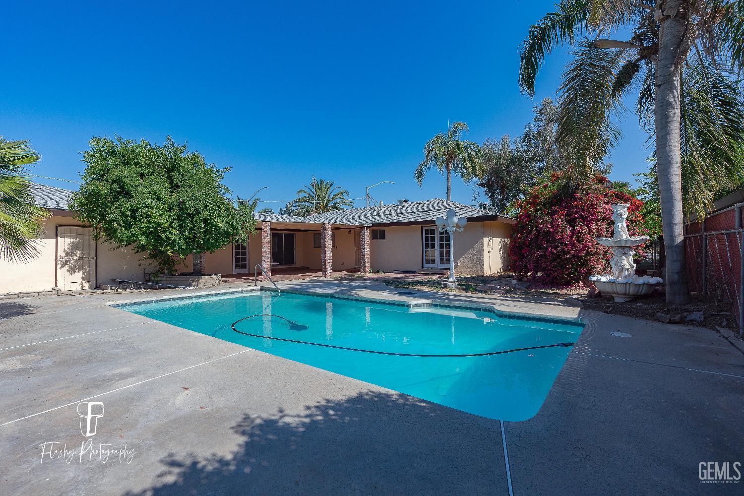 Undisclosed Address Bakersfield, CA 93308 - Photo 34 of 37 a view of a house with backyard patio and swimming pool