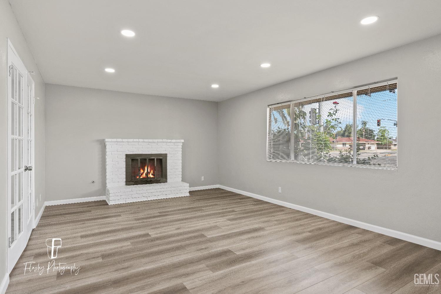 Undisclosed Address Bakersfield, CA 93308 - Photo 5 of 37 an empty room with wooden floor and windows