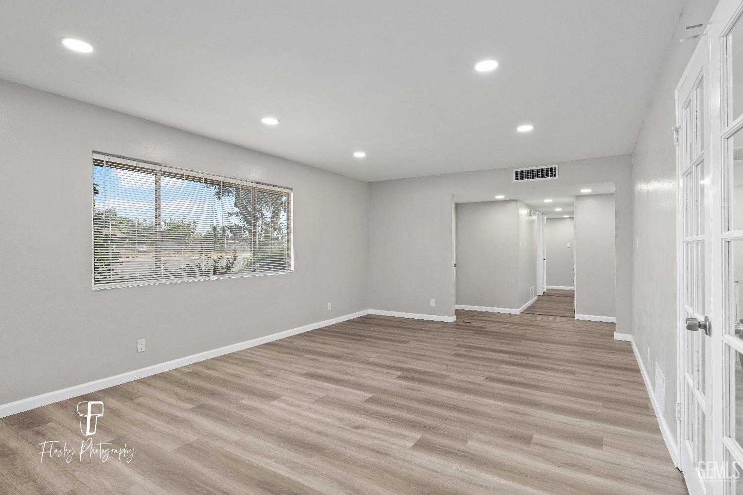 Undisclosed Address Bakersfield, CA 93308 - Photo 6 of 37 an empty room with wooden floor and windows