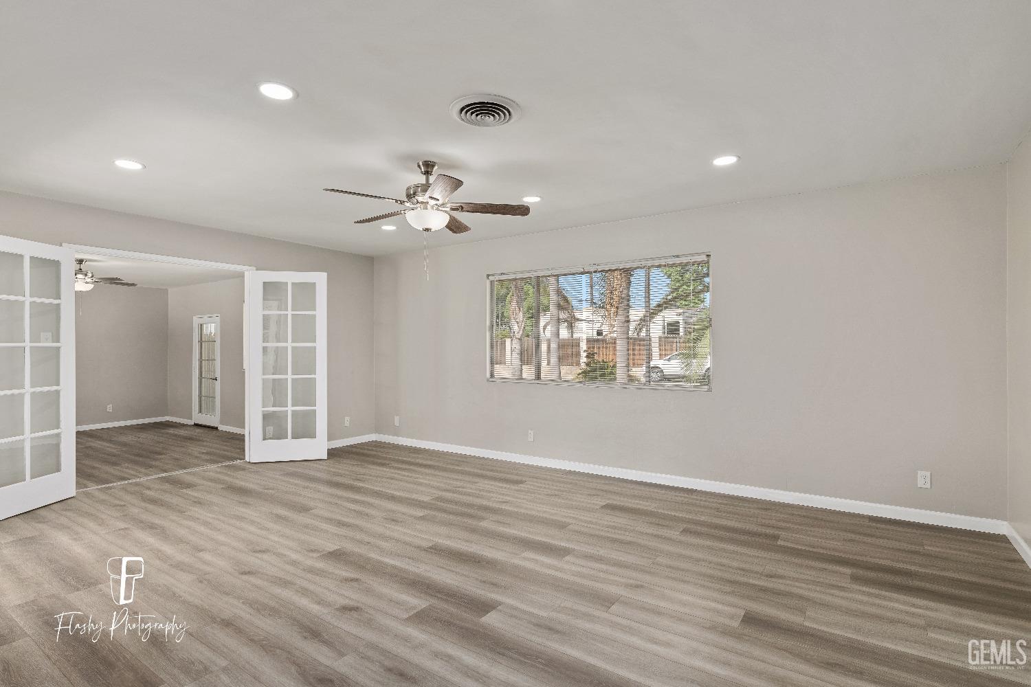 Undisclosed Address Bakersfield, CA 93308 - Photo 10 of 37 wooden floor in an empty room with a window