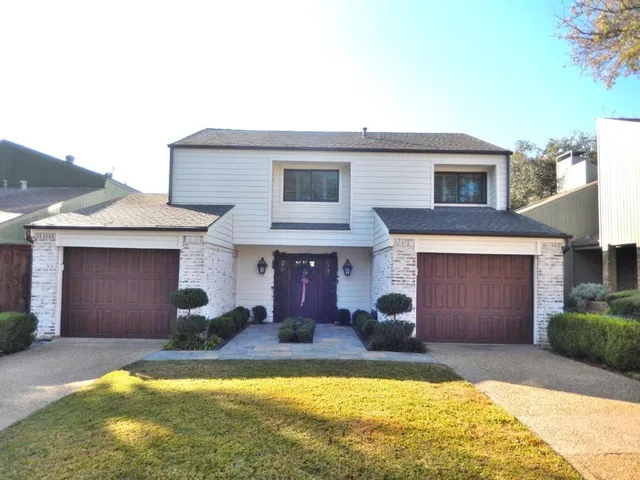 a view of a house with swimming pool in front of it