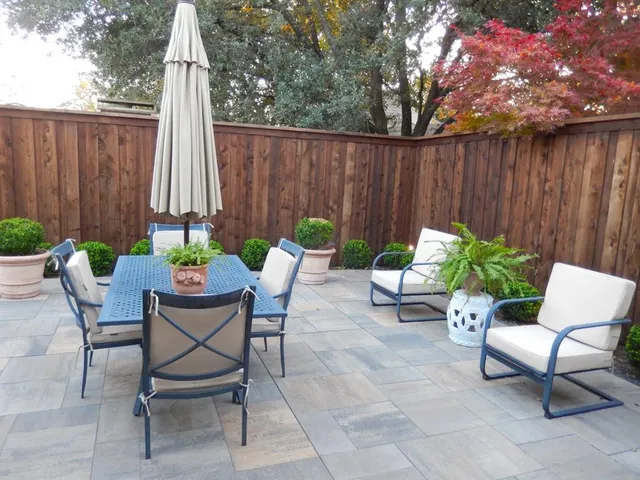 a backyard of a house with table and chairs