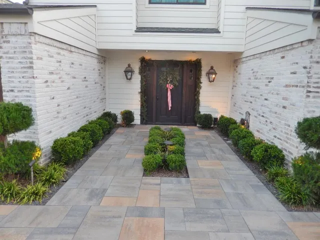 a front view of a house with potted plants