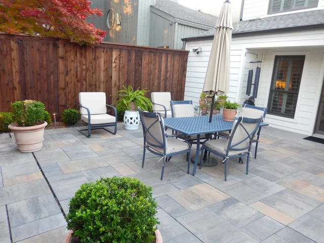 a view of a backyard with furniture and plants