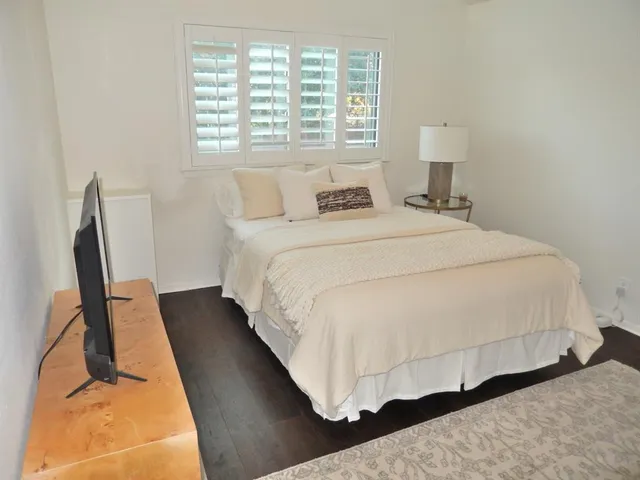 a bedroom with bed and a night stand