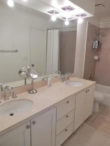 a bathroom with a double vanity sink mirror and double