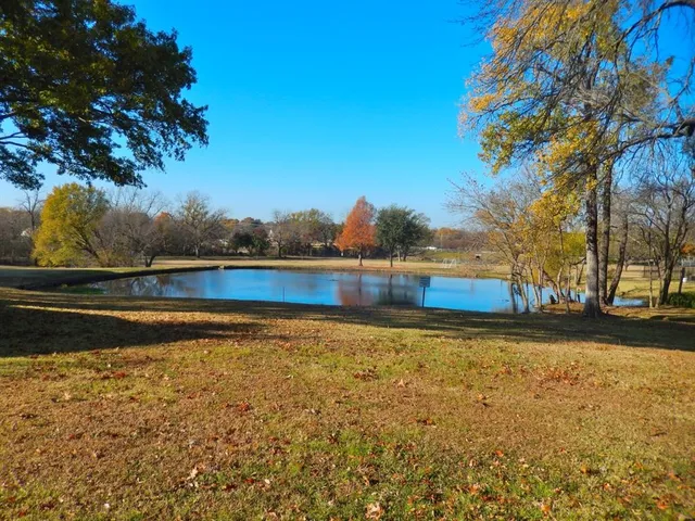 a view of swimming pool with yard and outdoor seating