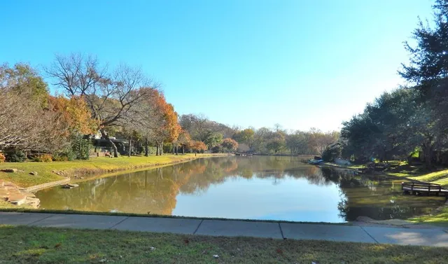 a view of a lake with houses in the back