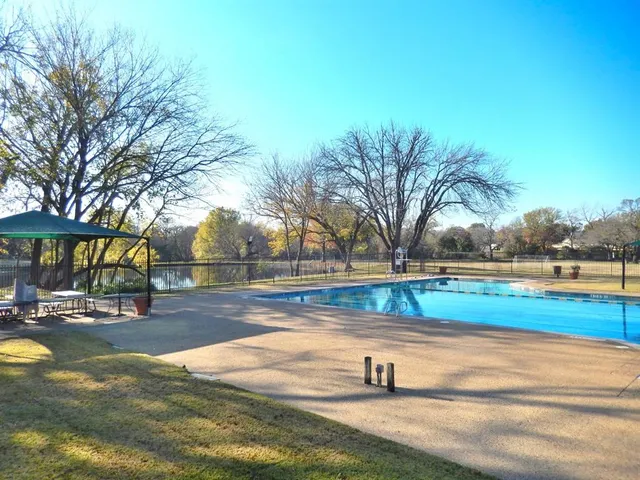 a view of swimming pool with outdoor seating and yard
