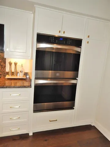 a stove top oven sitting inside of a kitchen