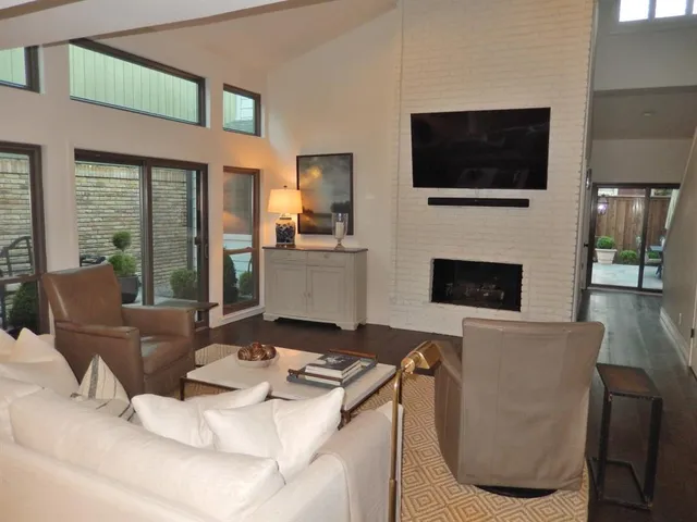 a living room with fireplace furniture and a flat screen tv